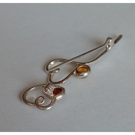Silver brooch with amber