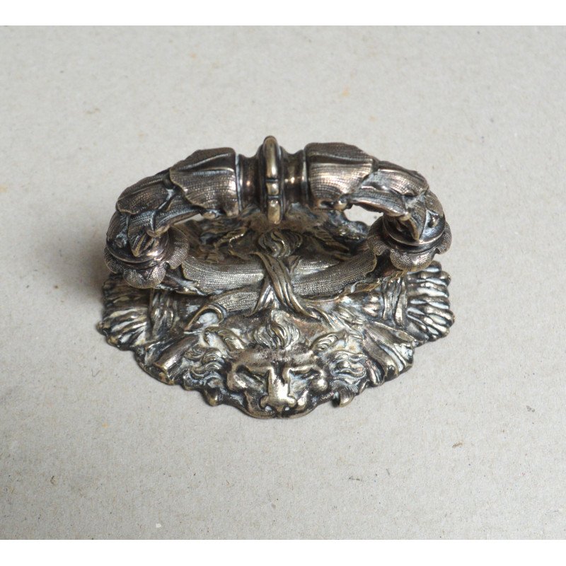 White metal handle decorated with lion heads,...